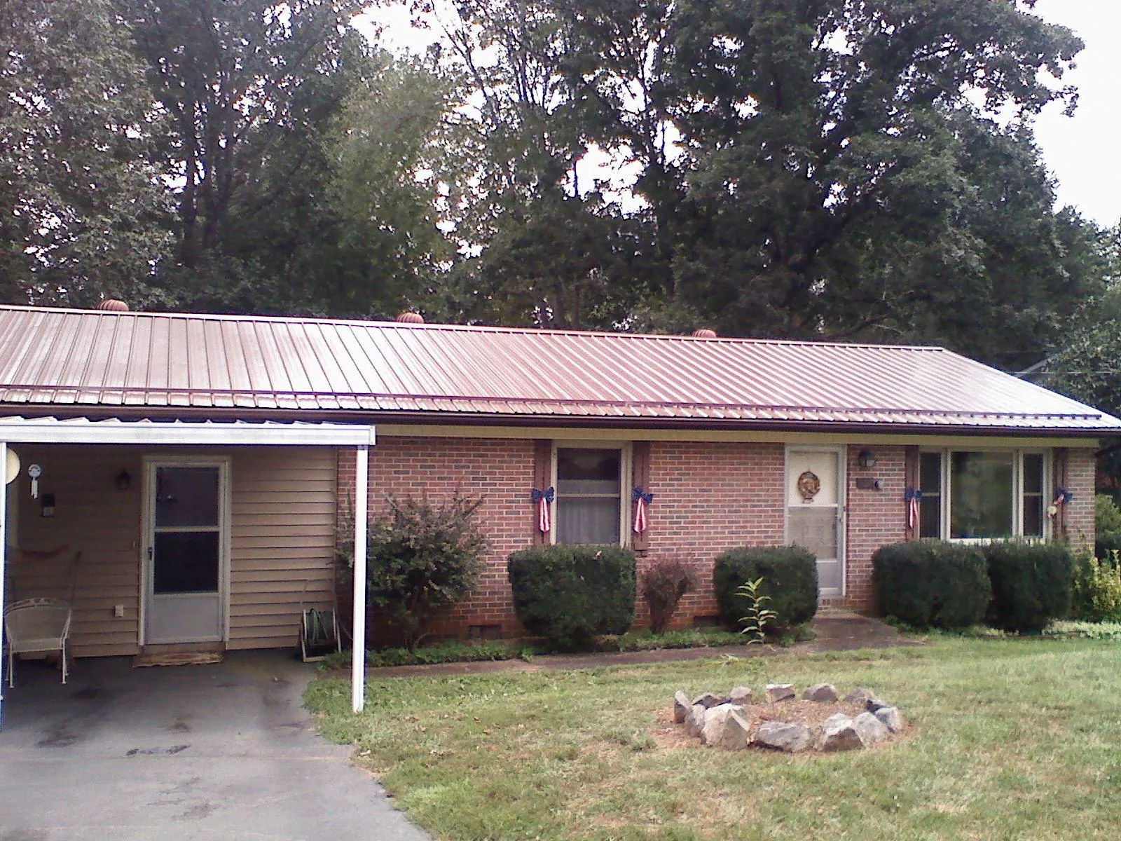 Bronze metal roof and carport on a brick ranch home — Roof Repair work by our crew in Eldena